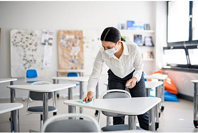 Teachers back at school after Covid-19 quarantine and cordoning off, disinfection of desks.